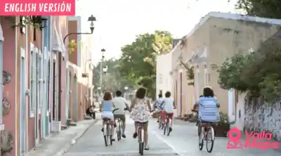 Cyclist on a quiet rural road near Valladolid Yucatan with low jungle on both sides